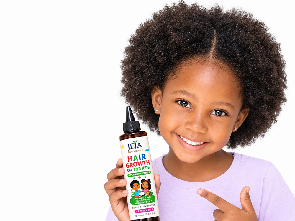 Smiling girl in a lilac top holding a bottle of JEJA Naturals Hair Growth Oil for Kids and pointing to it